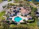 Stunning aerial view of a community clubhouse and pool surrounded by lush landscaping and palm trees at 13929 Fairway Island Dr # 825, Orlando, FL 32837