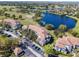 Aerial view of condos alongside a picturesque lake and golf course, offering beautiful community views at 13929 Fairway Island Dr # 825, Orlando, FL 32837