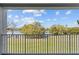 Balcony view showing calming lake surrounded by trees against a clear sky with fluffy clouds at 13929 Fairway Island Dr # 825, Orlando, FL 32837