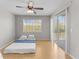 Well-lit bedroom with wood floors and sliding glass door to a balcony at 13929 Fairway Island Dr # 825, Orlando, FL 32837