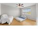 Bedroom with a sunny window, wood floors, and a cozy chair at 13929 Fairway Island Dr # 825, Orlando, FL 32837