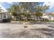 Multi-story condo building with ample parking and mature shade trees in a well-maintained community at 13929 Fairway Island Dr # 825, Orlando, FL 32837