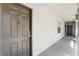 Hallway featuring unit X825 with a dark wooden door and modern knocker, leading to other units and the outside at 13929 Fairway Island Dr # 825, Orlando, FL 32837