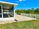 Backyard patio featuring a brick-laid floor, a white fence, and landscaping, with screened in porch at 1556 Lemon Ave, Winter Haven, FL 33881