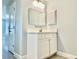 Well-lit bathroom featuring single vanity, a framed mirror, and tiled floors at 1556 Lemon Ave, Winter Haven, FL 33881