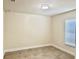 Neutral bedroom with tile flooring, a window for natural light, and neutral trim at 1556 Lemon Ave, Winter Haven, FL 33881