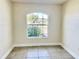 Bright bedroom featuring a large window overlooking the landscaped yard at 1556 Lemon Ave, Winter Haven, FL 33881