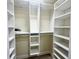 Walk-in closet featuring built-in shelving, rods, and ample storage space at 1556 Lemon Ave, Winter Haven, FL 33881