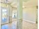 Inviting foyer with decorative glass door, tiled floor, and decorative column with stone accents at 1556 Lemon Ave, Winter Haven, FL 33881