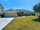 Charming single-story home featuring a manicured lawn and a two-car garage at 1556 Lemon Ave, Winter Haven, FL 33881