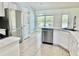 Modern kitchen with stainless steel appliances, white cabinetry, and a breakfast bar at 1556 Lemon Ave, Winter Haven, FL 33881