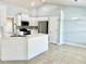 Open kitchen featuring a stainless refrigerator, modern cabinets, and stone backsplash at 1556 Lemon Ave, Winter Haven, FL 33881