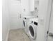 Functional laundry room features a washer, dryer, and storage space at 1556 Lemon Ave, Winter Haven, FL 33881