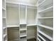 Organized walk-in closet with ample shelving and hanging space for efficient storage and wardrobe management at 1556 Lemon Ave, Winter Haven, FL 33881