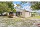 Backyard featuring patio, landscaping, and well-maintained lawn with an air conditioning unit at 165 Coralwood Cir, Kissimmee, FL 34743