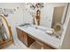 Well-lit bathroom featuring a long countertop with double sinks and a decorative mirror at 165 Coralwood Cir, Kissimmee, FL 34743