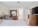 Spacious main bedroom with ceiling fan, tile floor, and wooden dresser at 165 Coralwood Cir, Kissimmee, FL 34743