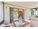 Covered patio area with tile flooring and outdoor seating, plants, and flowers at 165 Coralwood Cir, Kissimmee, FL 34743