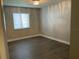 Bedroom with wood flooring, a window with blinds and modern light fixture at 165 Springwood Circle # A, Longwood, FL 32750