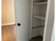 Well-lit linen closet featuring multiple shelves for storage at 165 Springwood Circle # A, Longwood, FL 32750