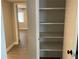 Spacious hall closet with multiple shelves for organized storage and access to bedroom at 165 Springwood Circle # A, Longwood, FL 32750