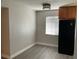 Kitchen featuring wood cabinets, a black refrigerator, and an overhead light fixture at 165 Springwood Circle # A, Longwood, FL 32750