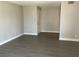 View of the well-lit living room featuring wood-look floors and neutral paint at 165 Springwood Circle # A, Longwood, FL 32750