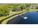 Aerial view showcasing a dock on a lake, perfect for recreational activities, surrounded by lush greenery and a walking path at 1659 Cherry Blossom Ter, Lake Mary, FL 32746