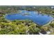 Aerial view of a serene lake surrounded by lush greenery and well-maintained homes, offering a peaceful and scenic setting at 1659 Cherry Blossom Ter, Lake Mary, FL 32746