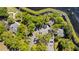 Aerial view of a parking lot surrounded by lush trees and well-maintained buildings in a tranquil community setting at 1659 Cherry Blossom Ter, Lake Mary, FL 32746