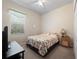 Bedroom featuring a bed, desk, and a window with plantation blinds at 1659 Cherry Blossom Ter, Lake Mary, FL 32746