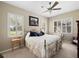 Bright bedroom with a metal frame bed, shutters on the windows, and a cozy, inviting atmosphere at 1659 Cherry Blossom Ter, Lake Mary, FL 32746