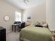 Cozy bedroom featuring a desk area and a comfortable bed with a window at 1659 Cherry Blossom Ter, Lake Mary, FL 32746