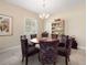 Elegant dining area featuring a round table, six chairs, and shuttered windows at 1659 Cherry Blossom Ter, Lake Mary, FL 32746