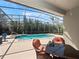 Relaxing screened lanai with a dining set overlooking the sparkling pool and lush landscaping at 1659 Cherry Blossom Ter, Lake Mary, FL 32746