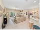 Bright living room featuring tile floors, neutral walls, ceiling fan, and sliding glass doors to the pool area at 1659 Cherry Blossom Ter, Lake Mary, FL 32746