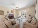 Spacious living room featuring couches, ceiling fan, tile floors, and a sliding door at 1659 Cherry Blossom Ter, Lake Mary, FL 32746