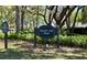 The Sawyer Lake Park sign surrounded by lush green ferns and trees at 1659 Cherry Blossom Ter, Lake Mary, FL 32746