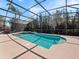 Sparkling screened pool with a spa, lounge seating, and lush tropical landscaping at 1659 Cherry Blossom Ter, Lake Mary, FL 32746