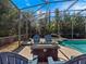 Inviting screened-in pool featuring a fire pit and Adirondack chairs for relaxation at 1659 Cherry Blossom Ter, Lake Mary, FL 32746