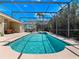 Sparkling screened pool with a spa, lounge seating, and lush tropical landscaping at 1659 Cherry Blossom Ter, Lake Mary, FL 32746