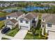 Beautiful aerial view of a two-story home with a lake in the background at 17394 Million Lakes Ct, Clermont, FL 34714