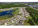 An aerial view showcases the neighborhood's layout, featuring well-spaced homes, natural ponds, and a lush green landscape at 17394 Million Lakes Ct, Clermont, FL 34714