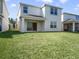 Spacious backyard with a view of the home's rear exterior at 17394 Million Lakes Ct, Clermont, FL 34714