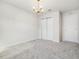 Light filled room with neutral carpet and paint, with a gold chandelier for a classic look and feel at 17394 Million Lakes Ct, Clermont, FL 34714