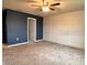 Large bedroom featuring contemporary wall paneling, neutral carpet, and a fresh coat of deep blue paint at 17394 Million Lakes Ct, Clermont, FL 34714