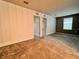 Carpeted bedroom with vertical wainscotting and neutral wall colors with access to the other areas of the home at 17394 Million Lakes Ct, Clermont, FL 34714