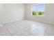 Well-lit bedroom featuring tile floors, a large window and ample natural light at 17394 Million Lakes Ct, Clermont, FL 34714