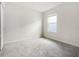 Bright bedroom featuring neutral carpeting and a window offering natural light at 17394 Million Lakes Ct, Clermont, FL 34714