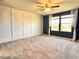Spacious bedroom with natural light streaming through the windows and a modern ceiling fan at 17394 Million Lakes Ct, Clermont, FL 34714